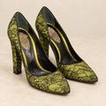 AI-enhanced studio-style presentation of La Perla pointed-toe pumps in chartreuse and black floral lace; see original item photos for exact condition