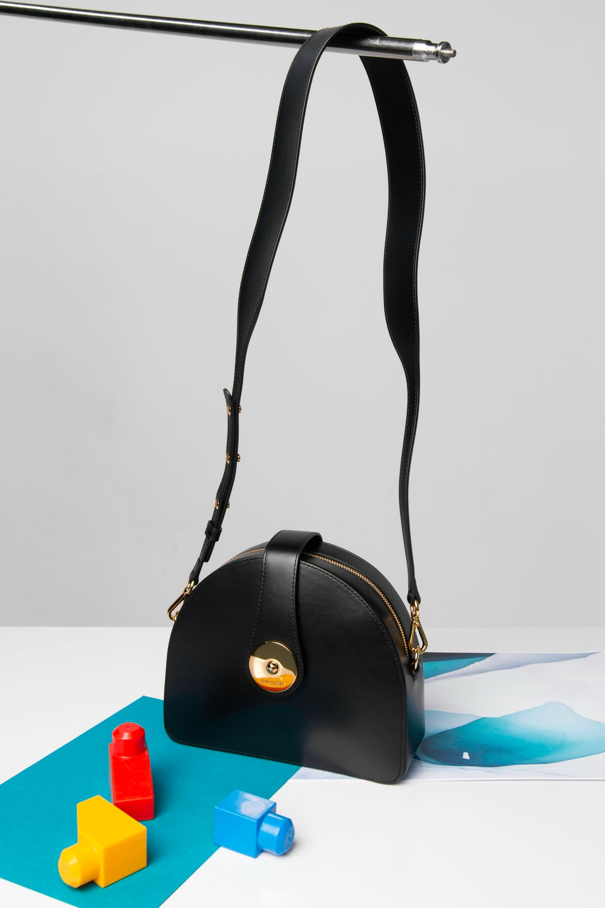 Black leather handbag editorial reference photograph by Trình Minh Thư, Unsplash. Illustrative reference only; not the exact Hermès Midnight Faubourg model.